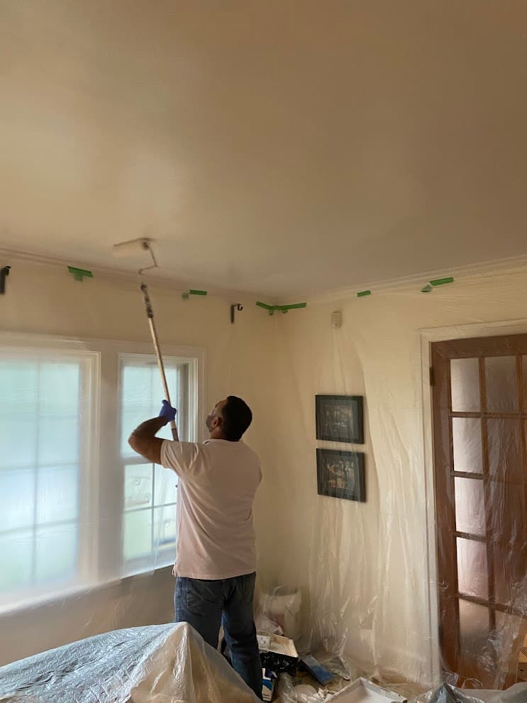 Professional painter at work with careful attention to detail