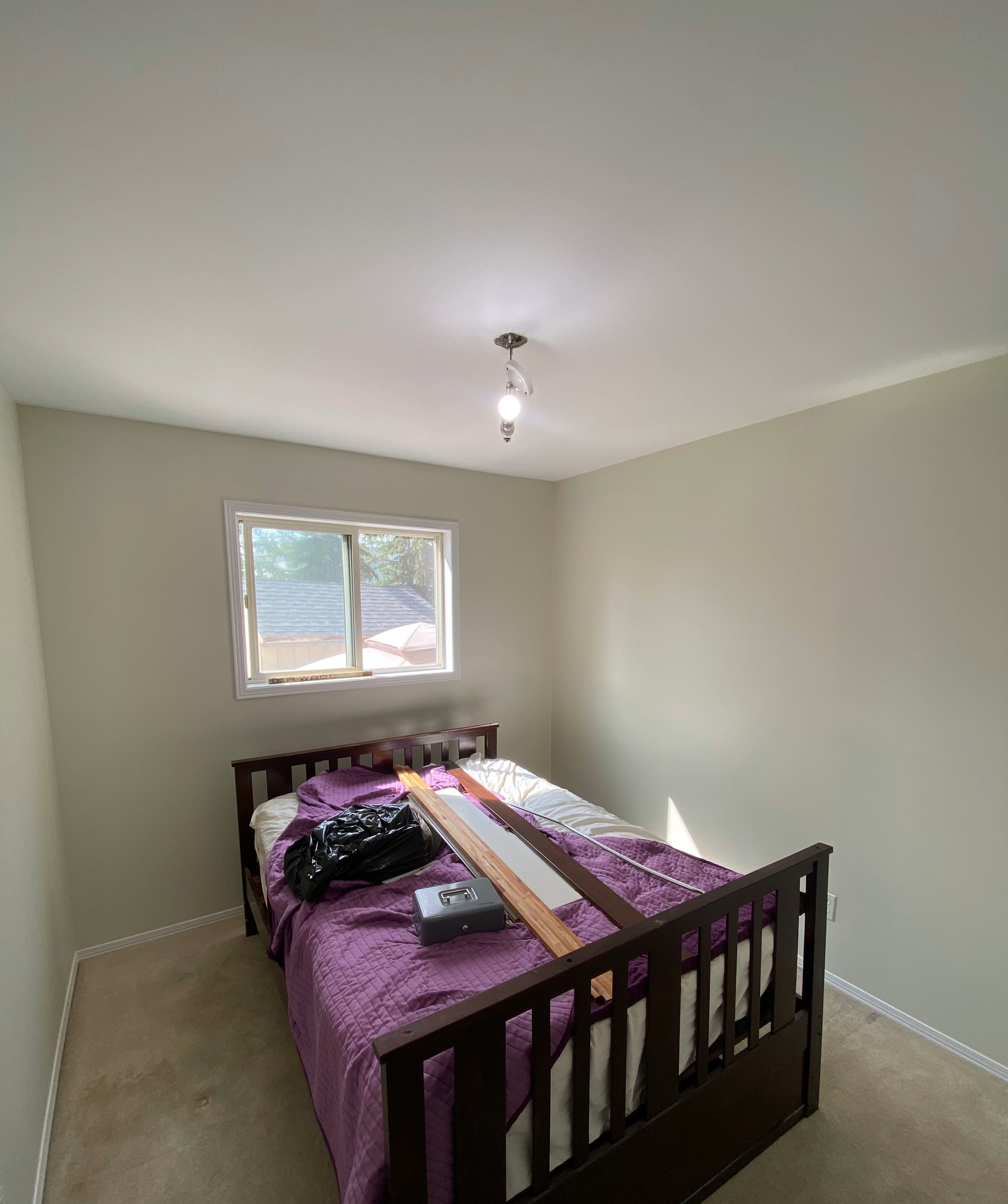 Ceiling painting with extension pole after smooth prep — plastic masking and clean edges