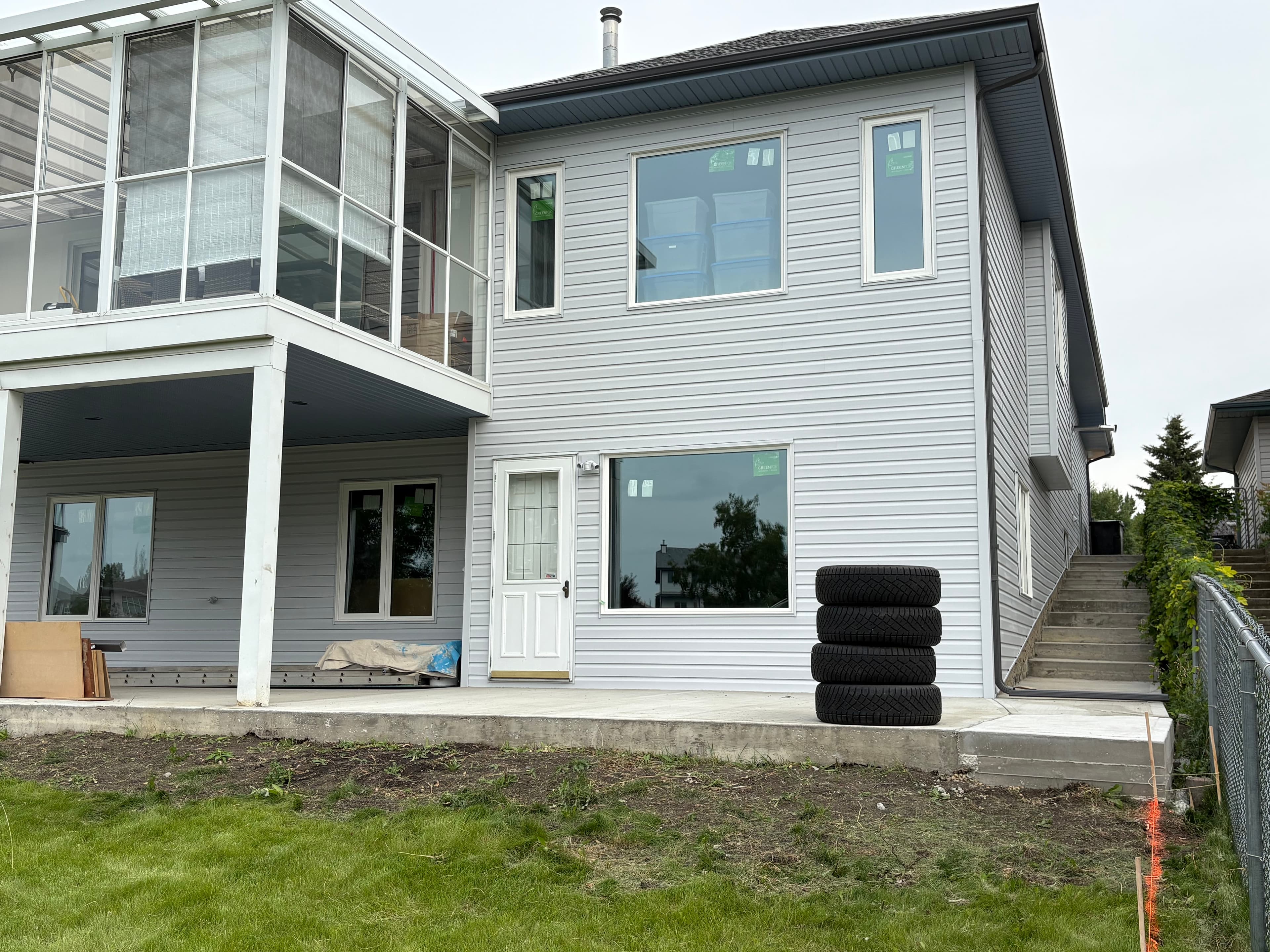 Rear exterior with refreshed siding, trim, and patio after professional exterior painting